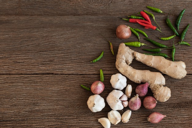 top-view-cooking-ingredients-are-onion-chilli-ginger-garlic-wooden-background-thailand-spices_125071-177